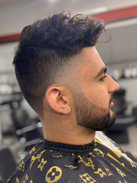 Low Taper Fade with Wavy Volume & Sculpted Beard - Clean low temple and neck taper with natural wavy volume on top and razor-sharp beard line.